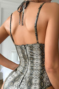 Back view of snakeskin print bodysuit with adjustable straps and zipper closure